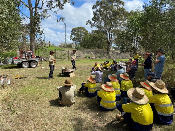 People at community planting workshop listening to one of the scientists
